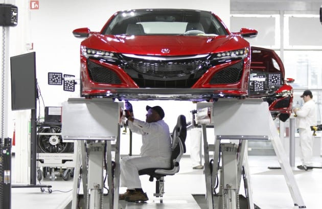 Carl Mason sits in the aligner chair during the wheel alignment process.  Because the NSX is so low, associates would have had to be in a crouched position for long periods of time to perform its alignment. This special chair hangs on rails and allows an associate comfort while doing this 45-minute process.