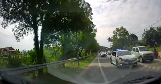 Police convoy seen overtaking on double-lined road