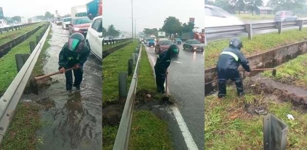 Man voluntarily digs path with a <em>cangkul</em> so water can escape into drain along flooded Pasir Gudang Highway