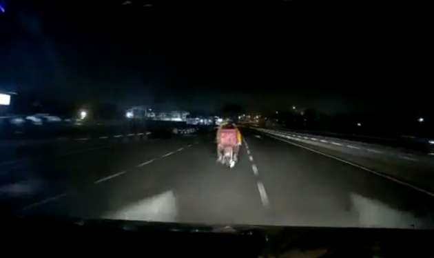 Car speeding down dark stretch of a Malaysian highway slams into a motorcycle without tail lights