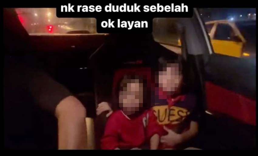 Two young children shown in front seat of car in video as driver appears to be drag racing another vehicle 1574442