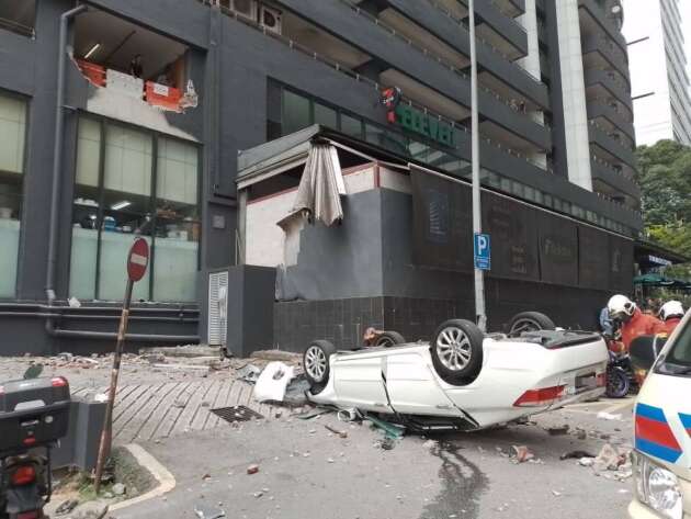 Car rams into concrete barrier on first floor of car park in KL, plunges to the ground roof first, driver injured