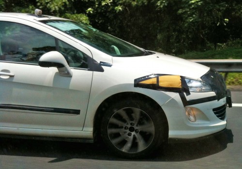White Peugeot 408 with black tape testing on the NSE