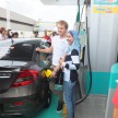 Mercedes GP F1 driver Nico Rosberg refuels lucky customers’ cars at Petronas’ 1,001st station
